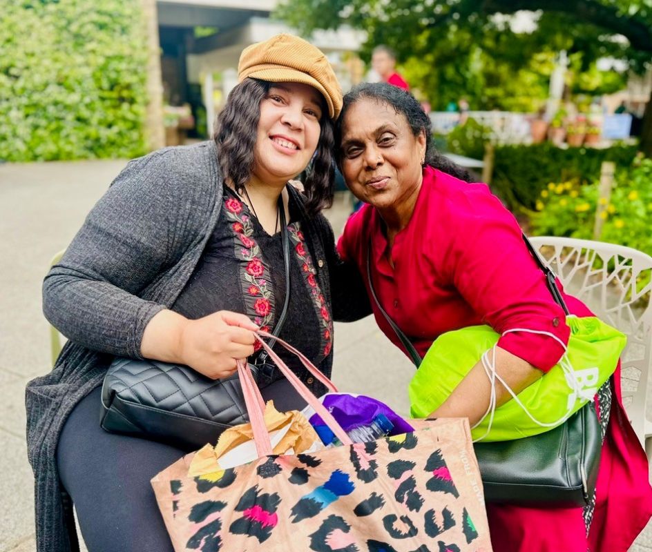 photo of a female enjoying tea raising her cup in 'cheers'